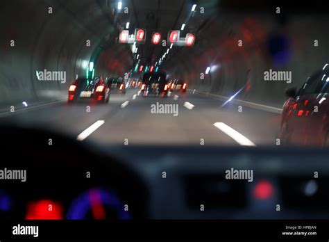 car driving through tunnel; highway tunnel at night Stock Photo - Alamy