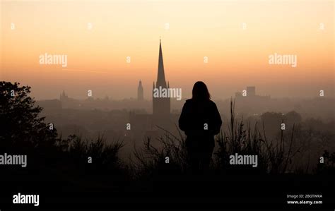 Sunset city skyline with silhouette person looking over - Norwich ...