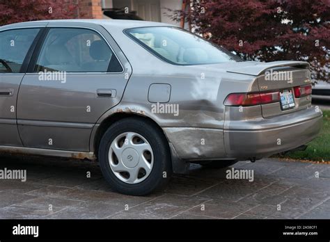 poor repair job on a damaged car body panel Stock Photo - Alamy