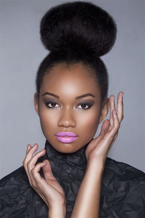 Messy Bun Hairstyles For Black Hair : The Natural Bun - HerHairPin : This updo features a ...