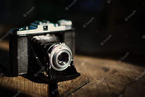 Premium Photo | Vintage old camera on a wooden table. retro style ...