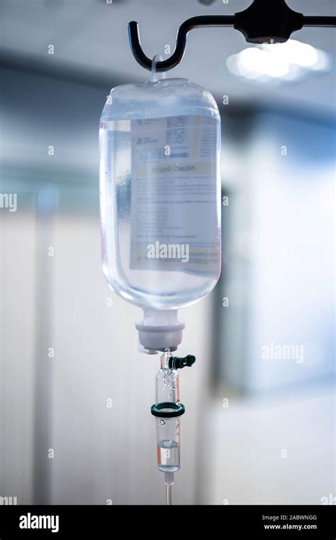 Saline Solution IV Drip Fluid for Infusion in Hospital Background. Intravenous infusion drip ...