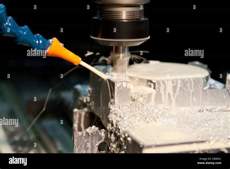 CNC Milling machine cutting with coolant Stock Photo - Alamy