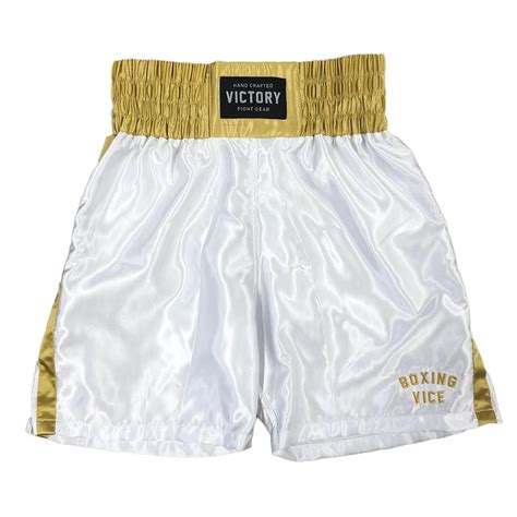 a white and gold boxing shorts with the words victory written on it's side