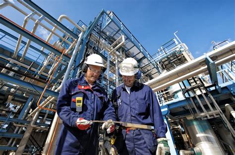 Oil, gas, pipelines and workers. Oil and gas workers in front of large refinery, , #Sponsored, # ...