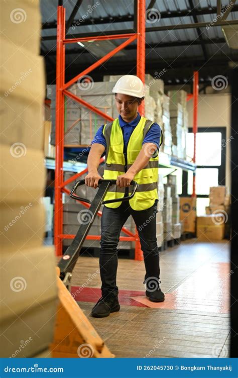 Determined Asian Male Warehouse Worker Pulling the Pallet Truck ...