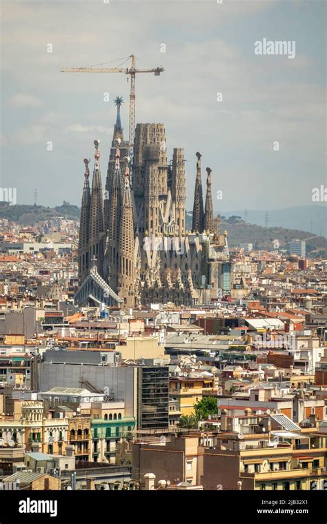 View of the Sagrada Familia cathedral still under construction, surrounded by buildings, in ...