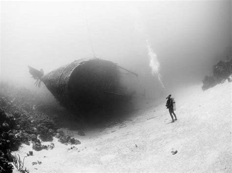 Scuba diver exploring a shipwreck : thalassophobia