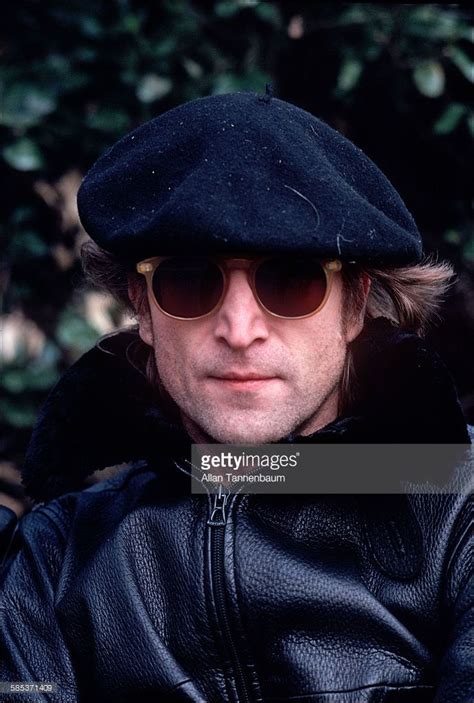 Close-up portrait of British musician John Lennon , dressed in a ...