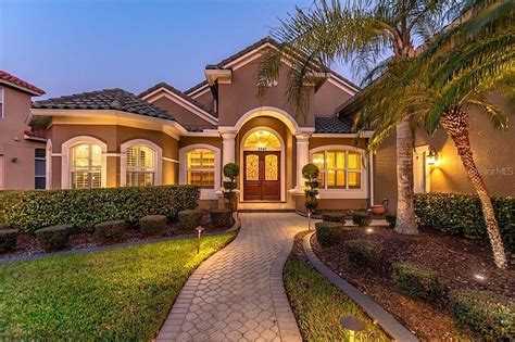 Spanish Style Home with Palm Trees and Lights in Orlando, FL