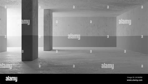 Abstract large, empty, modern concrete room, half painted walls and pillars with indirect light ...