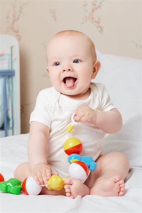 Cute Smiling Baby Laughing and Smiling with a Toy in His Hand. L Stock Photo - Image of ...