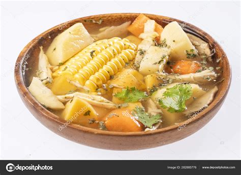 Colombian cuisine: ajiaco soup with chicken and vegetables close up in ...