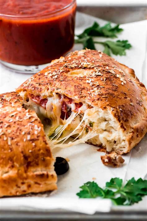 This homemade Calzone is a delicious Italian favorite! Pizza dough is filled with cheese, meats ...