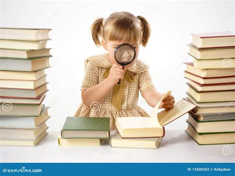 Little Girl Looking At Book Through Magnifier Stock Photography - Image: 13400202