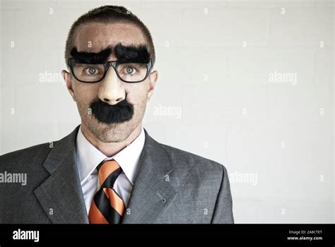 Businessman hiding his identity wearing a disguise of glasses with thick eyebrows and mustache ...