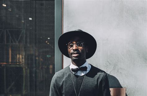 Man Wearing Hat and Bowtie in Front of Concrete Wall · Free Stock Photo