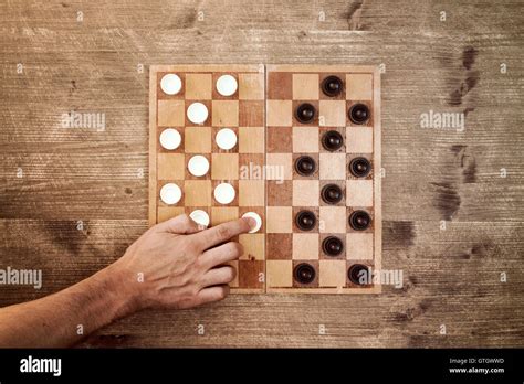 Man starting play draughts checkers board game Stock Photo - Alamy