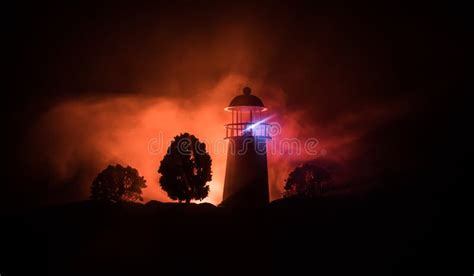 Lighthouse with Light Beam at Night with Fog. Old Lighthouse Standing ...