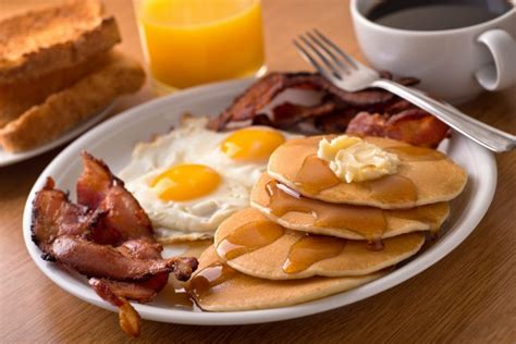 Breakfast with bacon, eggs, pancakes, and toast