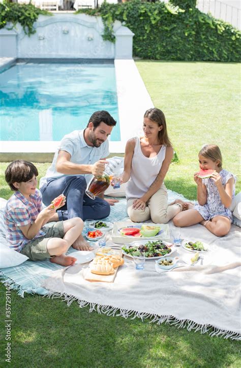 Family enjoying picnic in backyard Stock Photo | Adobe Stock