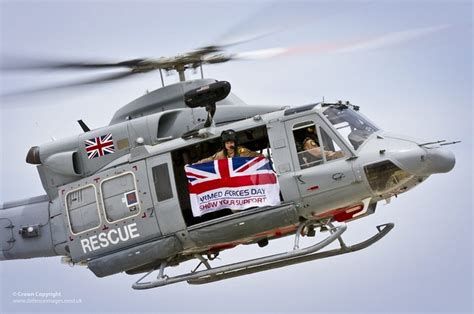 RAF Griffin Helicopter Flying the Armed Forces Day Flag