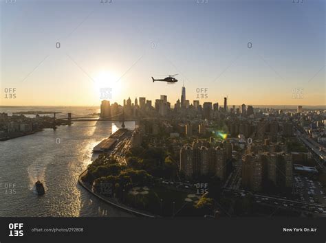 Helicopter flying over Manhattan at sunset, New York City, NY stock ...