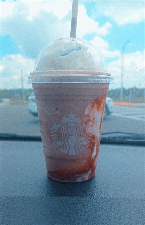 a starbucks drink sitting on top of a table