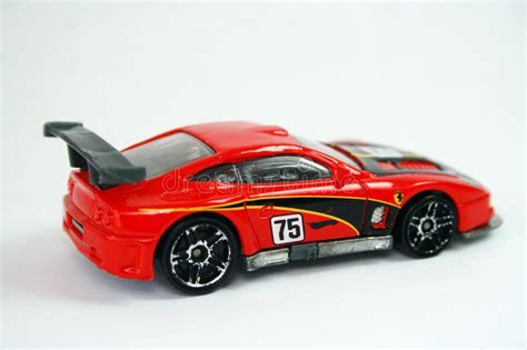 Toy racing car. A red toy racing car, number 75 on a white background # ...