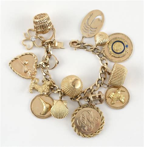 Sold Price: 14KT GOLD CHARM BRACELET WITH FOURTEEN CHARMS Most charms are 14kt gold. Includes ...