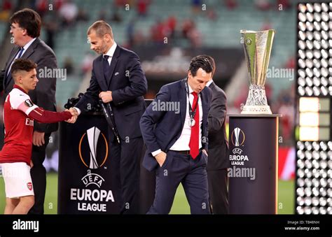 Arsenal manager Unai Emery looks dejected as he walks past the trophy ...