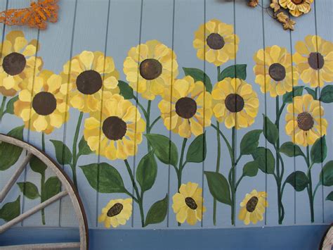 Sunflowers being painted on the side of a home. Forever in a field of ...