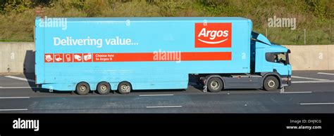 Argos delivery trailer and truck driving along motorway Stock Photo - Alamy