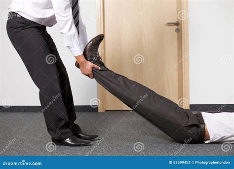 Businessmen Pulling Colleague S Leg at Office Stock Image - Image of death, shoe: 53699453