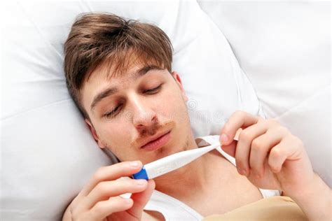 Sick Man with a Thermometer Stock Image - Image of problem, illness: 175917071