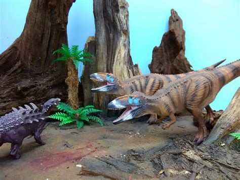 Model dinosaur diorama scene featuring Papo Polacanthus and CollectA's Carcharodontosaurus. By ...