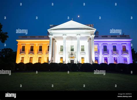 The White House is lit in purple, white, and gold to honor the suffrage movement in Washington ...