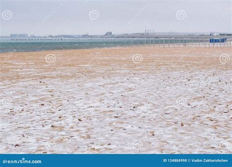 Snow in Winter on the Sea Sand Beach with Coastal Town on Background ...