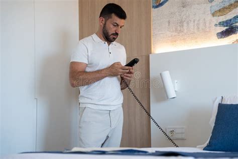 Attractive Young Businessman in Hotel Room, Calling Reception. Stock Image - Image of modern ...