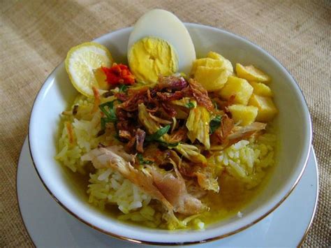 Soto Ayam, Yellow Chicken Soup. Usually eat with steamed rice, boiled egg, potato chips, chopped ...