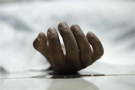 dead body laying on a floor.Focus at the hand 7102917 Stock Photo at Vecteezy