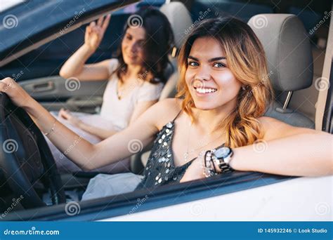 Portrait of Two Attractive Girls Driving a Car. they Smiling To Camera ...