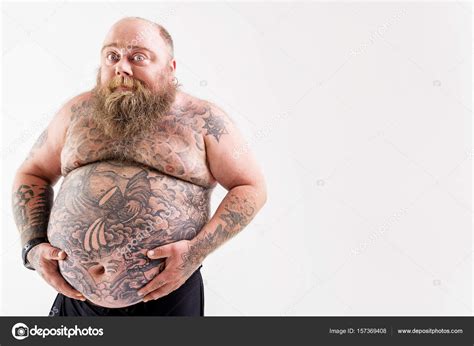 Hombre gordo alegre posando con abdomen grande: fotografía de stock © iakovenko123 #157369408 ...