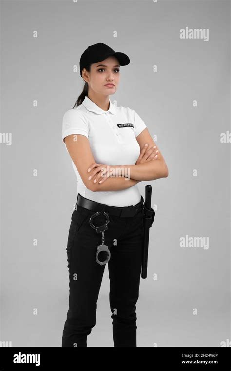 Female security guard in uniform on color background Stock Photo - Alamy