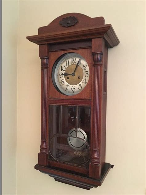 Item # 21 -- Antique Pendulum Wall Clock. Working condition. 16" x 9" x 31" H. Please refer to ...