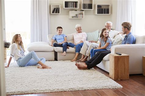 Multi Generation Family Relaxing On Sofa At Home Together - Innovative ...