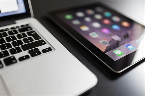 Black Ipad Beside Macbook Air · Free Stock Photo