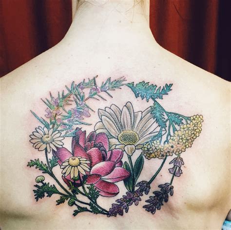 a woman's back with flowers and leaves on it