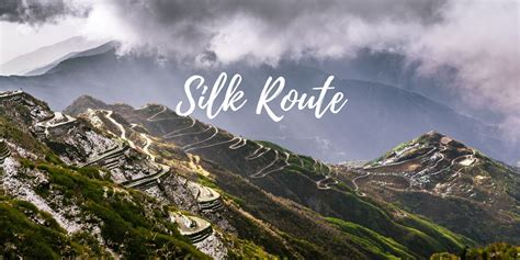 the words silk route on top of a mountain with clouds in the sky above it