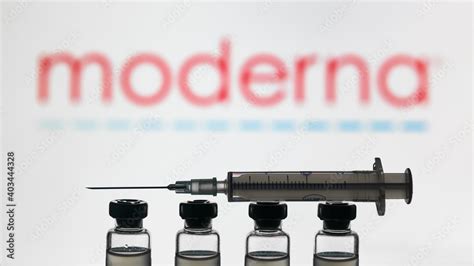 Moderna COVID-19 vaccine concept, syringe and bottles on logo background Stock Photo | Adobe Stock